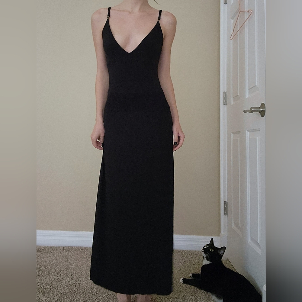 Floor length black dress with elastic waist, adjustable straps, plunge neckline